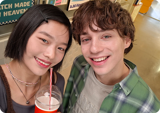 Two people smiling in camera selfie
