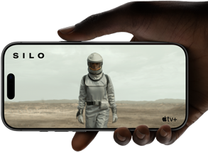 A hand holds an iPhone 17 Pro, Silver, horizontal, video playback on all-screen display demonstrating battery life