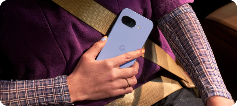 Two friends looking at a Google Pixel 9a