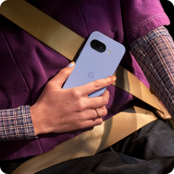 Two friends looking at a Google Pixel 9a
