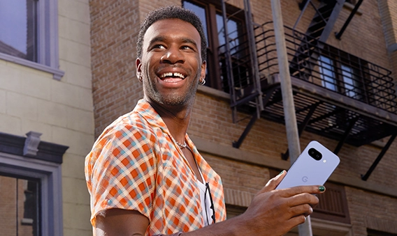 Happy guy holding Google Pixel 9a