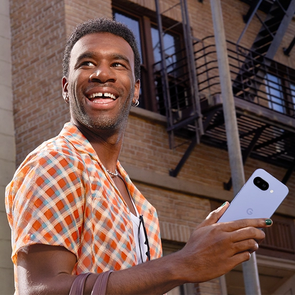 Happy guy holding Google Pixel 9a