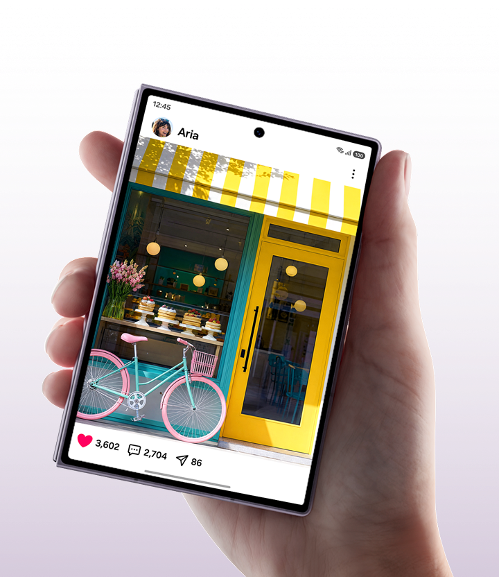 A hand holding the Fold8 device showing a social media post of a bakery