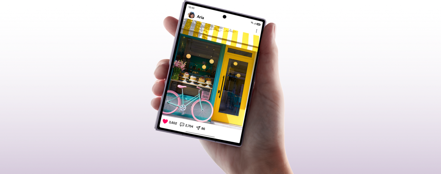 A hand holding the Fold8 device showing a social media post of a bakery