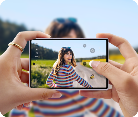 An image of someone holding the device taking a photo of a lady smiling